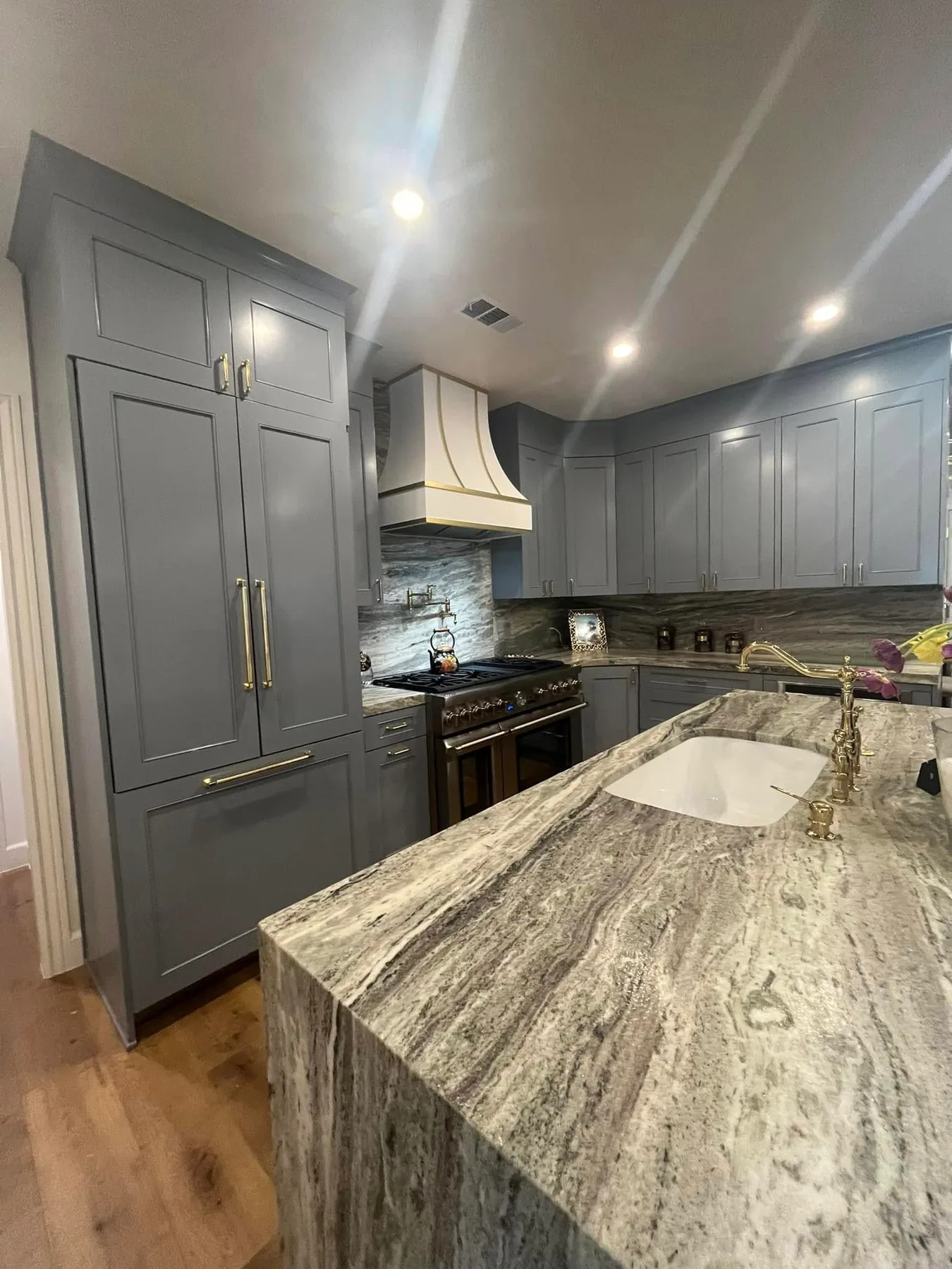 Quartzite counters and matching slab backsplash — Kitchen