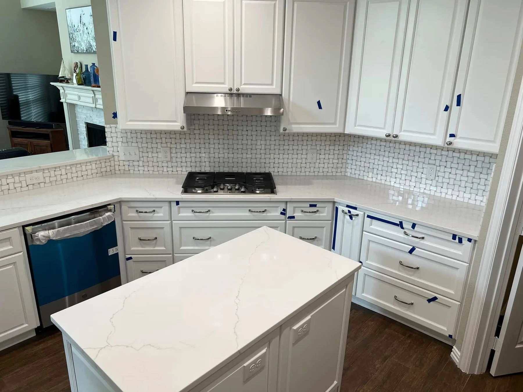 White quartz counters and island — Kitchen