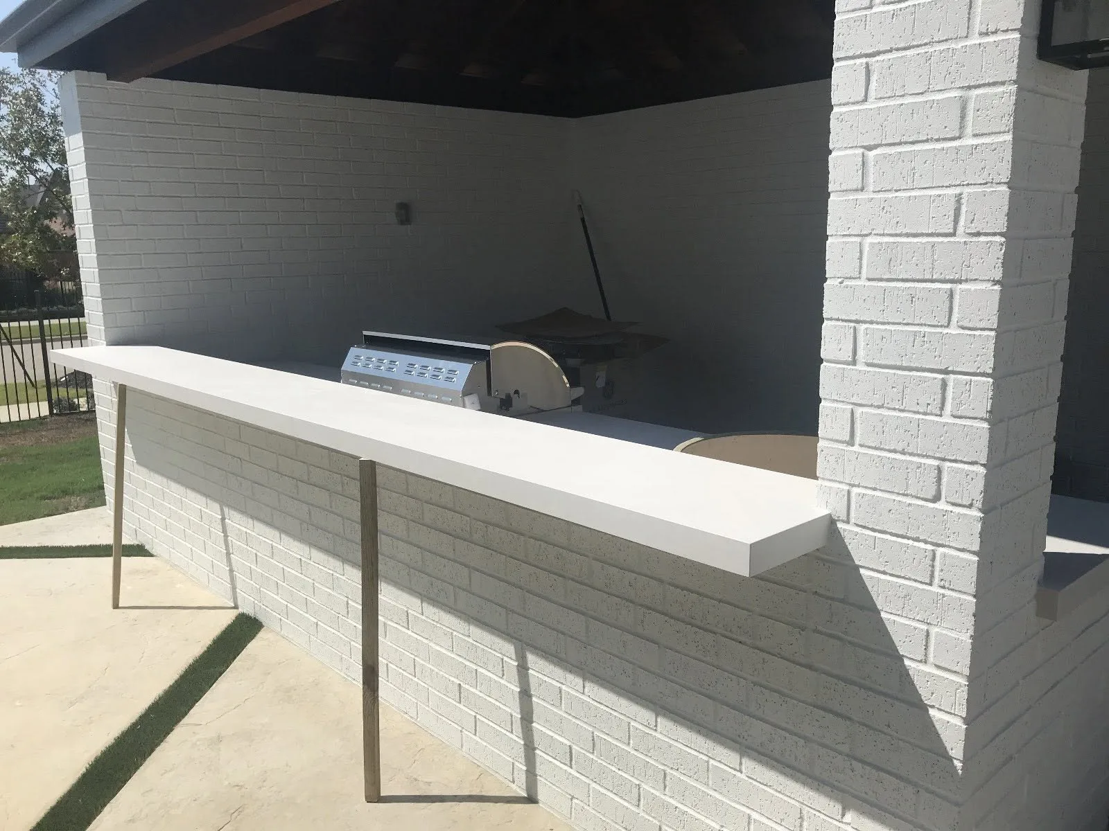 Cantilevered white quartz bar ledge — Outdoor