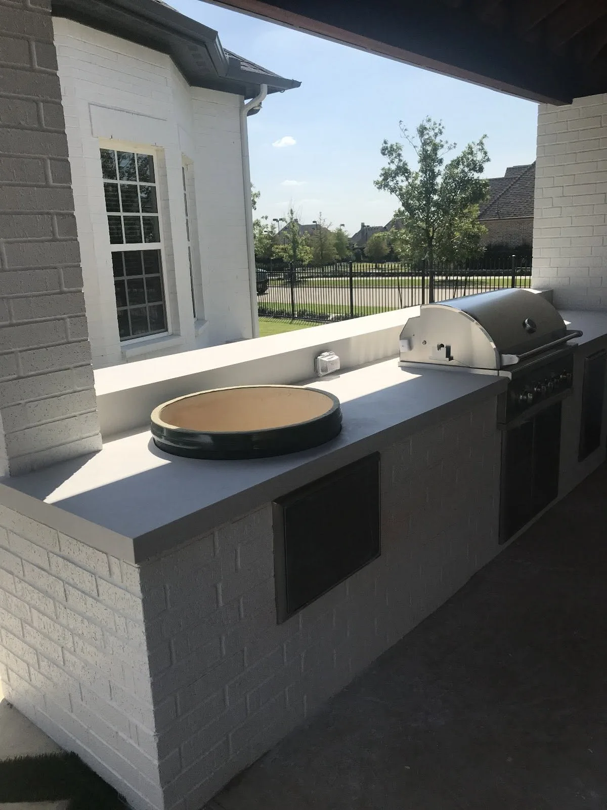 Grey quartz counter run around a built-in grill — Outdoor